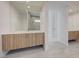 Modern bathroom featuring double vanities and a large mirror at 1600 Pleasant Bay Ct, Henderson, NV 89011