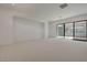 Spacious bedroom with neutral carpet and sliding doors to a patio at 1600 Pleasant Bay Ct, Henderson, NV 89011