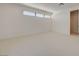 Bright bedroom with a row of windows near the ceiling and neutral carpet at 1600 Pleasant Bay Ct, Henderson, NV 89011