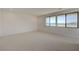Bright bedroom features neutral carpet and large windows with picturesque views of the surrounding landscape at 1600 Pleasant Bay Ct, Henderson, NV 89011