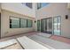 Modern home featuring a courtyard with stone pavers and a sleek double-door entrance at 1600 Pleasant Bay Ct, Henderson, NV 89011