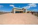 Exterior view of the rear of the home and an expansive backyard at 1600 Pleasant Bay Ct, Henderson, NV 89011