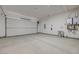 Two car garage with a white garage door, gray sealed concrete floor and two water heaters at 1600 Pleasant Bay Ct, Henderson, NV 89011