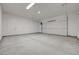 Spacious two car garage with a white door, gray walls and gray sealed concrete flooring at 1600 Pleasant Bay Ct, Henderson, NV 89011