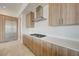 Close-up on modern kitchen with cooktop, wood cabinets, and stainless steel appliances at 1600 Pleasant Bay Ct, Henderson, NV 89011
