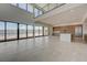 Open-concept living space with high ceilings, a modern kitchen, and waterfront view at 1600 Pleasant Bay Ct, Henderson, NV 89011