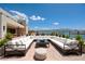 Inviting outdoor lounge area with a large sectional sofa and views of a tranquil lake at 1600 Pleasant Bay Ct, Henderson, NV 89011
