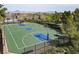 A basketball court is surrounded by lush greenery and a well-maintained fence at 1725 Cypress Manor Dr, Henderson, NV 89012