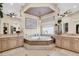 Lavish bathroom with a soaking tub, chandelier, and dual vanities with a decorative mirror at 1725 Cypress Manor Dr, Henderson, NV 89012