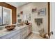 A luxurious bathroom with double vessel sinks, granite countertops, and elegant fixtures at 1725 Cypress Manor Dr, Henderson, NV 89012