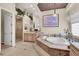 Elegant bathroom features a jacuzzi tub, chandelier, and marble accents at 1725 Cypress Manor Dr, Henderson, NV 89012