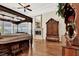 Cozy main bedroom featuring a fireplace, hardwood floors, and large windows at 1725 Cypress Manor Dr, Henderson, NV 89012