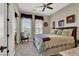A serene bedroom features a comfortable bed, arched windows, and a sitting area with natural light at 1725 Cypress Manor Dr, Henderson, NV 89012
