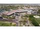 An aerial showcases clubhouse architecture, nearby golf course, and cart parking at 1725 Cypress Manor Dr, Henderson, NV 89012