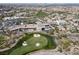 An aerial shot highlights golf course, clubhouse amenities, and residential homes at 1725 Cypress Manor Dr, Henderson, NV 89012