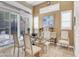 Elegant dining area with a glass table, shuttered windows, and stylish decor, creating a refined atmosphere at 1725 Cypress Manor Dr, Henderson, NV 89012