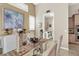 Charming dining area with a glass table, stylish chairs, and view into laundry room, perfect for Gathering meals at 1725 Cypress Manor Dr, Henderson, NV 89012