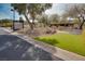 Community sign with directions near a landscaped entrance featuring desert plants and green turf at 1725 Cypress Manor Dr, Henderson, NV 89012