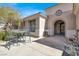 Cozy front entrance with a decorative fountain, an outdoor seating area, and a beautiful front door at 1725 Cypress Manor Dr, Henderson, NV 89012