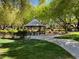 Scenic community gazebo surrounded by lush trees and landscaping, perfect for relaxation and social gatherings at 1725 Cypress Manor Dr, Henderson, NV 89012