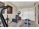 A home gym featuring various workout equipment and a full-length mirror for exercise monitoring at 1725 Cypress Manor Dr, Henderson, NV 89012