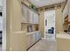 A hallway features ample cabinet space and connects different areas of the home with neutral decor at 1725 Cypress Manor Dr, Henderson, NV 89012