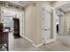 A hallway with an arched doorway leads to different areas of the home with transitional decor at 1725 Cypress Manor Dr, Henderson, NV 89012