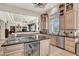 Expansive kitchen with granite countertops, stainless steel appliances, wine fridge and open layout to living area at 1725 Cypress Manor Dr, Henderson, NV 89012