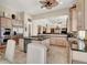 Open kitchen with stainless steel appliances, double oven, and an island cooktop, seamlessly connected to the living area at 1725 Cypress Manor Dr, Henderson, NV 89012