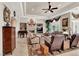 Spacious living room with a fireplace, recessed lighting, and large windows showcasing a beautiful chandelier at 1725 Cypress Manor Dr, Henderson, NV 89012