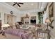A comfortable living room features a fireplace, columns, neutral colors, and plush seating for relaxation at 1725 Cypress Manor Dr, Henderson, NV 89012