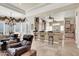 Open-concept living space with bar seating, a dining area, and comfortable armchairs, ideal for entertaining at 1725 Cypress Manor Dr, Henderson, NV 89012