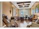 Home office with wood floors, a ceiling fan, a large window and comfortable seating at 1725 Cypress Manor Dr, Henderson, NV 89012