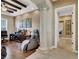 A well-appointed home office features wood floors, decorative columns, and comfortable seating at 1725 Cypress Manor Dr, Henderson, NV 89012