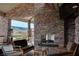 Outdoor seating area with stone fireplace, comfortable furniture, and scenic views at 1725 Cypress Manor Dr, Henderson, NV 89012