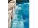 Water flowing from lion statues into a crystal blue backyard pool at 1725 Cypress Manor Dr, Henderson, NV 89012