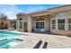 A refreshing pool and spa, perfect for relaxation and entertaining, with a covered patio and ample seating at 1725 Cypress Manor Dr, Henderson, NV 89012