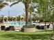 Inviting community pool area with cabanas, lounge chairs, and mature landscaping, offering a resort-like experience at 1725 Cypress Manor Dr, Henderson, NV 89012