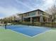 Community tennis court with a modern building backdrop, set within meticulously kept landscaping and fencing at 1725 Cypress Manor Dr, Henderson, NV 89012
