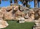 Artificial grass area with a waterfall feature at 1725 Cypress Manor Dr, Henderson, NV 89012
