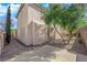 Spacious backyard featuring stone landscaping, a tall brick wall, and mature trees at 177 Rocky Star St, Henderson, NV 89012