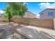 Spacious backyard featuring stone landscaping, a tall brick wall, and mature trees at 177 Rocky Star St, Henderson, NV 89012