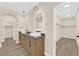 Bathroom featuring double vanity sinks with framed mirrors, wood cabinets, and large walk-in closet at 177 Rocky Star St, Henderson, NV 89012