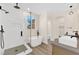 Bright bathroom featuring a soaking tub, glass enclosed shower, and double vanity sinks at 177 Rocky Star St, Henderson, NV 89012