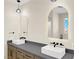 Stylish bathroom featuring double vanity, modern fixtures, and backlit mirrors, providing ample space and elegant design at 177 Rocky Star St, Henderson, NV 89012