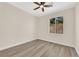 A bedroom offers wood-look flooring and a window view of lush greenery at 177 Rocky Star St, Henderson, NV 89012