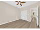 This bright bedroom features wood-look floors, a ceiling fan, and a closet with sliding doors at 177 Rocky Star St, Henderson, NV 89012