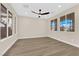 Large bedroom with multiple windows offering ample natural light and a ceiling fan at 177 Rocky Star St, Henderson, NV 89012