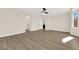Large primary bedroom showcasing stylish wood-look flooring, plentiful natural light, and a ceiling fan at 177 Rocky Star St, Henderson, NV 89012