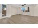 Bright, spacious bedroom with modern ceiling fan, wood-look floors, and access to outdoor space, bathed in natural light at 177 Rocky Star St, Henderson, NV 89012